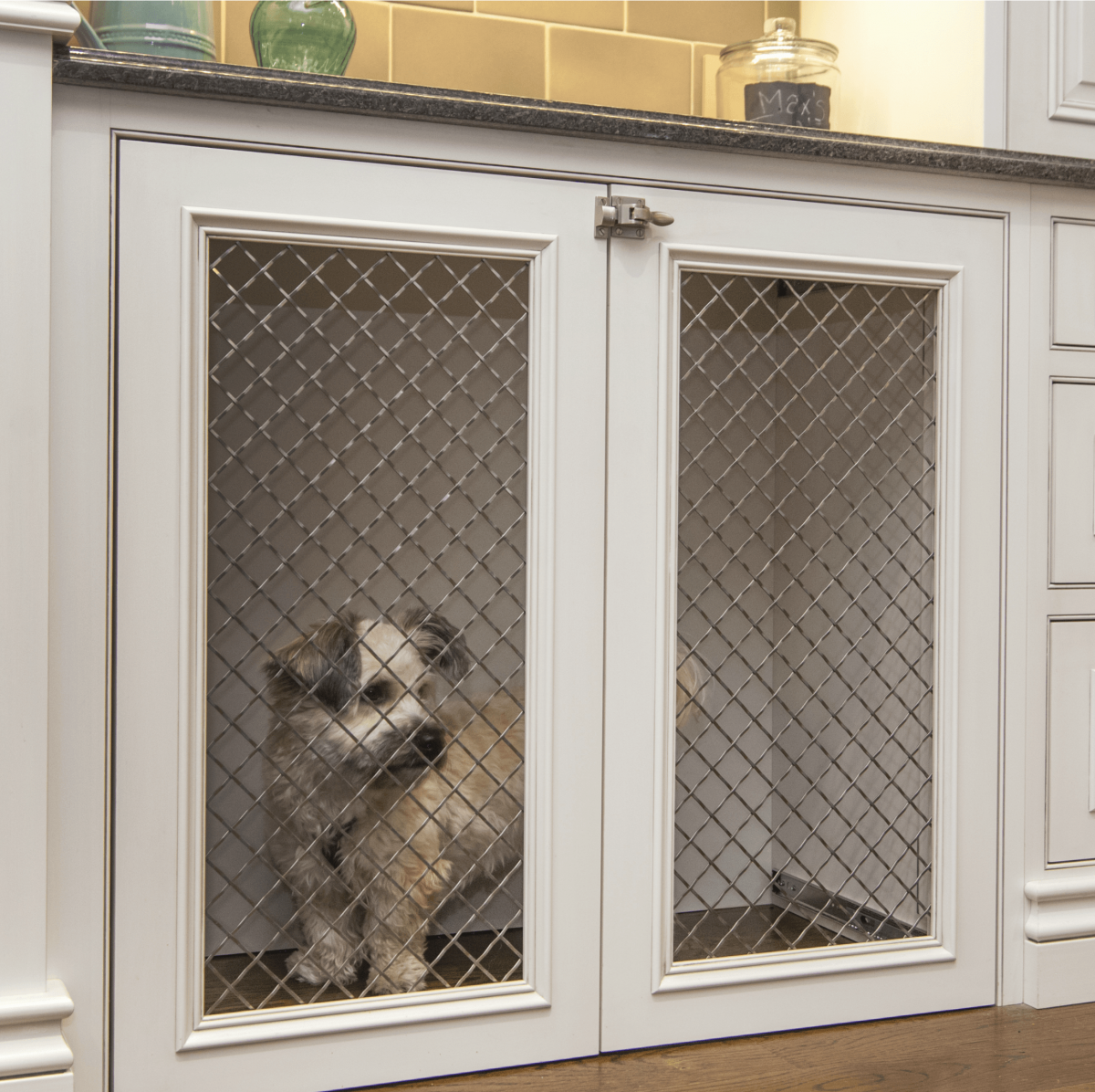 Custom dog crate built into kitchen cabinetry